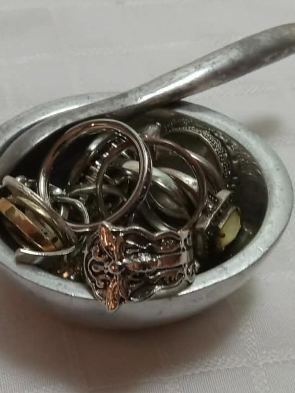 Elegant vintage pewter salt cellar bowl with matching spoon full of rings